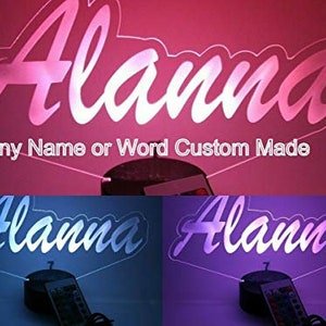 May include: A custom-made light-up sign with the name "Alanna" in a white, cursive font. The sign is illuminated with a pink light in the top image and blue and purple lights in the bottom images. The sign is on a black base with a remote control.