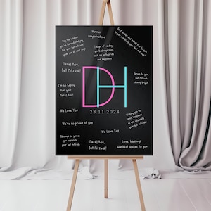 May include: A black chalkboard easel with the letters "DH" in pink and blue. The board is decorated with messages and well wishes for a Bat Mitzvah celebration. The date "23.11.2024" is written on the board.