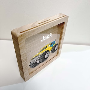 May include: A wooden frame with a clear acrylic insert featuring a cartoon monster truck and the name "Jack".