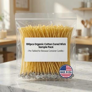 May include: A clear plastic resealable bag containing 100 pieces of organic cotton cored candle wicks with metal tabs. The white label reads 100pcs Organic Cotton Cored Wick Sample Pack - Pre-Tabbed for Beeswax Container Candles - with a Made in USA badge.