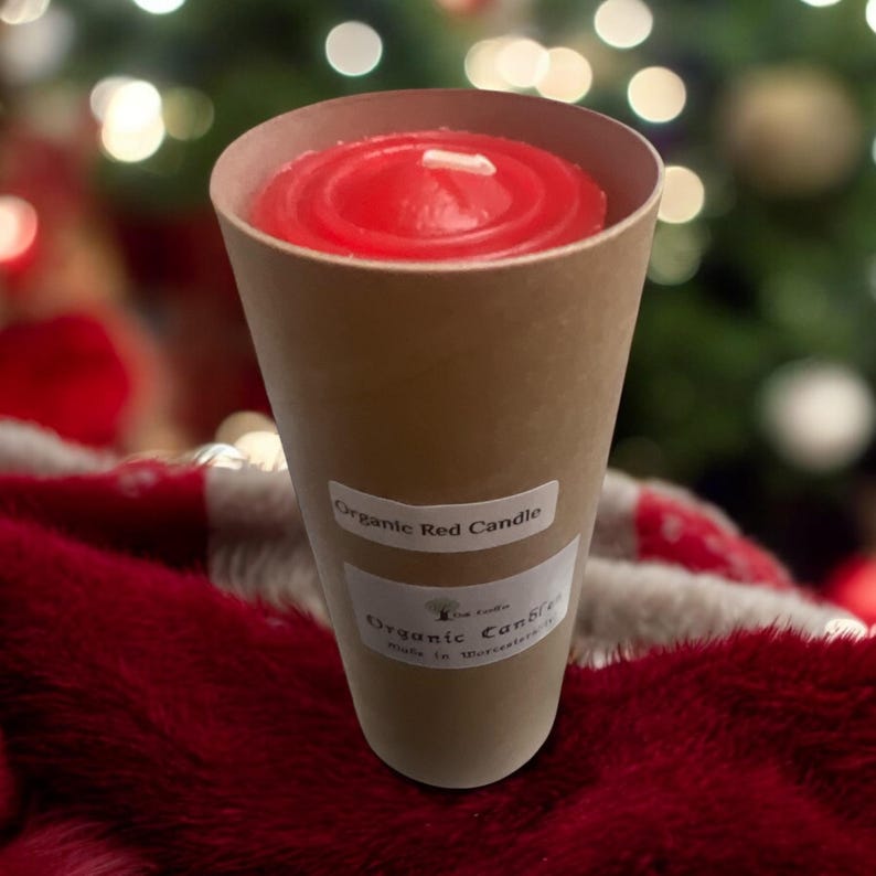 May include: A red organic candle in a brown paper cone. The candle is labeled "Organic Red Candle" and "Organic Candle Made in Worcestershire".