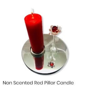 May include: A red pillar candle on a mirrored base with a glass flower decoration. The candle is unscented.