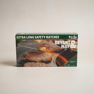 May include: A box of "EXTRA LONG SAFETY MATCHES" with a picture of burgers on a grill. The brand name "BRYANT & MAY" is displayed in white and red. The box is green and white.