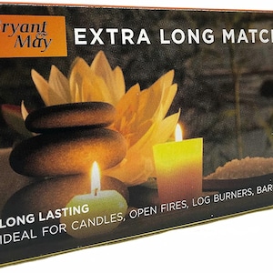 May include: A rectangular box of Bryant & May Extra Long Matches. The packaging features a graphic of stacked dark stones, a yellow lotus flower, and two lit candles. The text reads Bryant & May, Extra Long Matches, and Long Lasting.