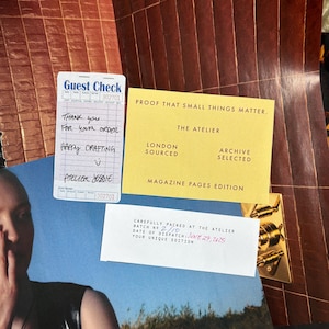 May include: A collection of ephemera, including a guest check with handwritten text, a yellow card with text, and a white card with text. The guest check reads "Thank you for your order" and "Happy Crafting". The yellow card says "Proof that small things matter."