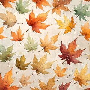 May include: A repeating pattern of maple leaves in shades of orange, yellow, red, and muted green against a light cream background. The leaves are depicted in a watercolor style with visible veins and pointed lobes, scattered across the surface.