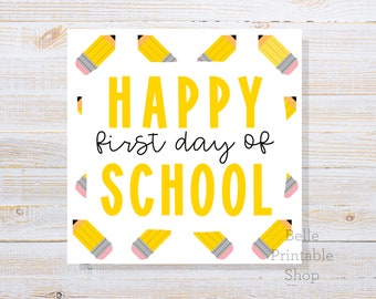 May include: A white printable sign with the text "HAPPY first day of SCHOOL" in yellow letters. The background is decorated with a pattern of yellow pencils with pink erasers.