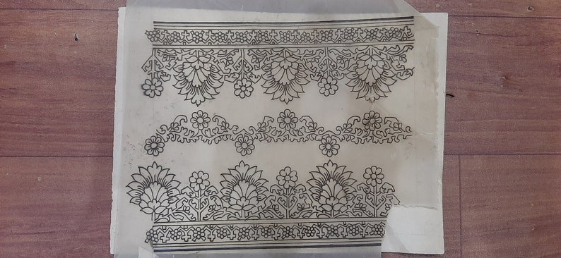 May include: A black and white floral design on a white background. The design is made up of repeating patterns of flowers and leaves.
