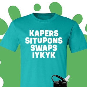 May include: A turquoise t-shirt with the text "KAPERS SITUPONS SWAPS IYKYK" in white.  A pair of white sneakers and a silver water bottle with a black lid and a black straw are also pictured.