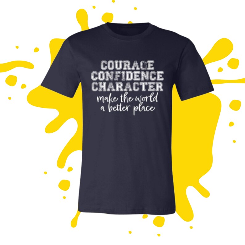 May include: Navy blue t-shirt with white text that reads "COURAGE CONFIDENCE CHARACTER make the world a better place".