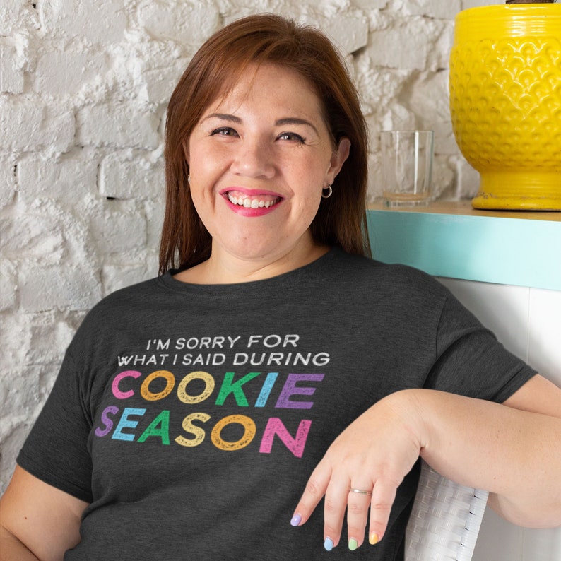 May include: A dark grey t-shirt with the text "I'm sorry for what I said during cookie season" in colorful letters. The letters are in a retro style font.