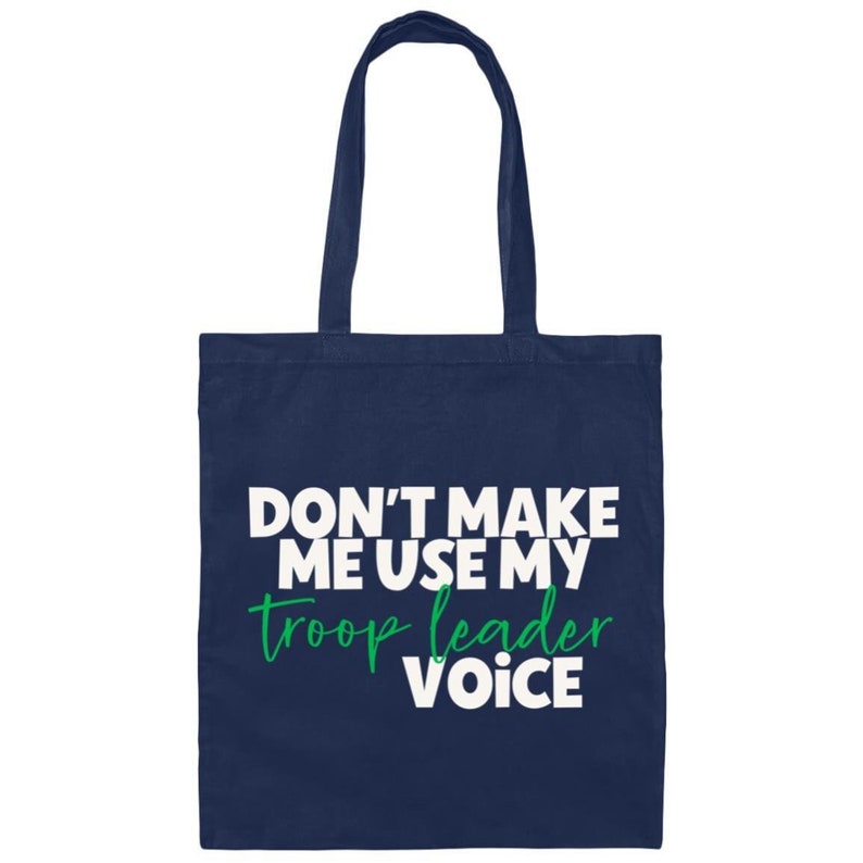 May include: A navy blue tote bag with the text "Don't make me use my troop leader voice" in white and green lettering.