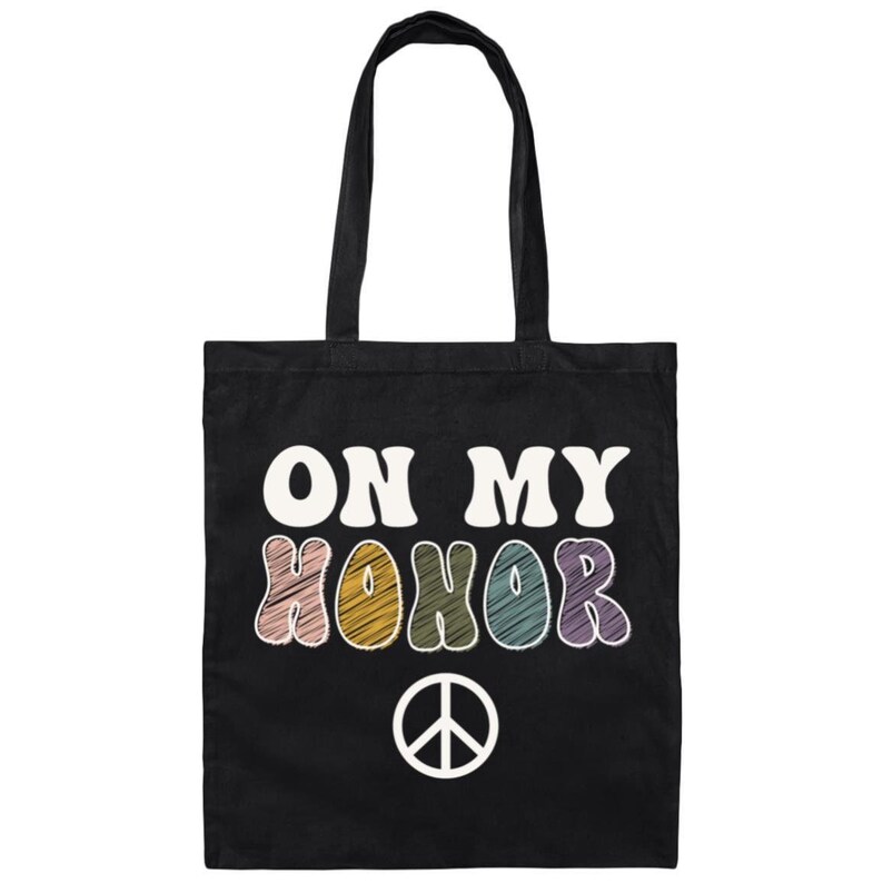 May include: Black tote bag with the text "ON MY HONOR" in colorful, retro-style lettering and a peace sign below.