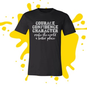 May include: Black t-shirt with white text that reads "COURAGE CONFIDENCE CHARACTER make the world a better place"