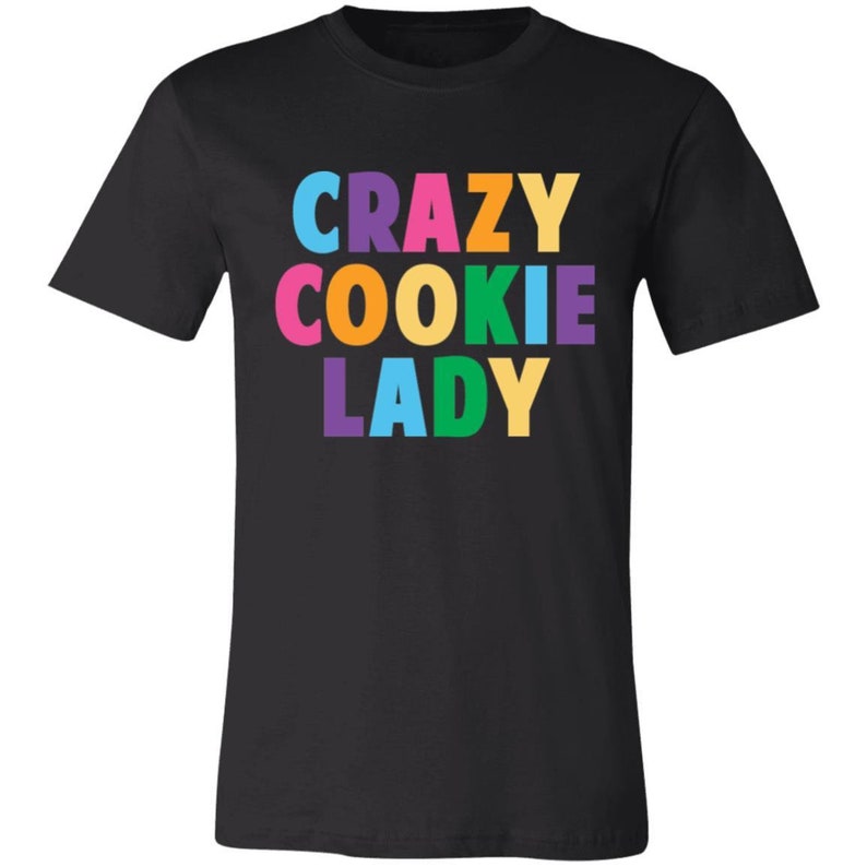 May include: Black t-shirt with the text "CRAZY COOKIE LADY" in rainbow colours.