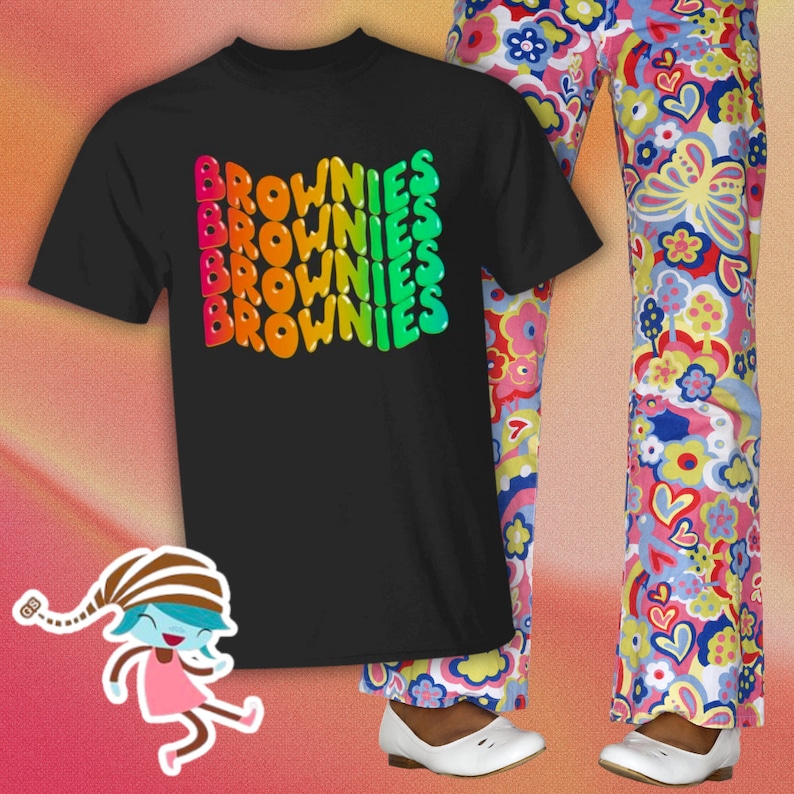 May include: A black t-shirt with a rainbow graphic of the word "BROWNIES" repeated five times.