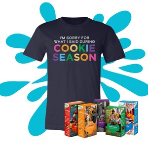 May include: A navy blue t-shirt with the text "I'm sorry for what I said during cookie season". The text is in rainbow colors. There are six boxes of Girl Scout Cookies in the image. The boxes are for Thin Mints, Samoas, Do-si-dos, Tagalongs, Lemonades, and S'mores.