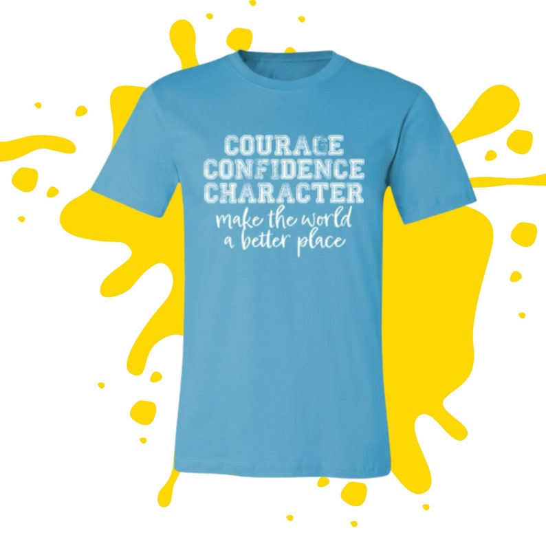 May include: Light blue t-shirt with white text that reads "COURAGE CONFIDENCE CHARACTER make the world a better place".