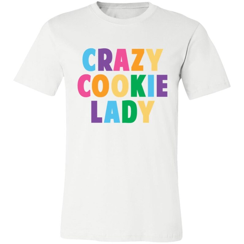 May include: White t-shirt with the text "CRAZY COOKIE LADY" in rainbow colours.