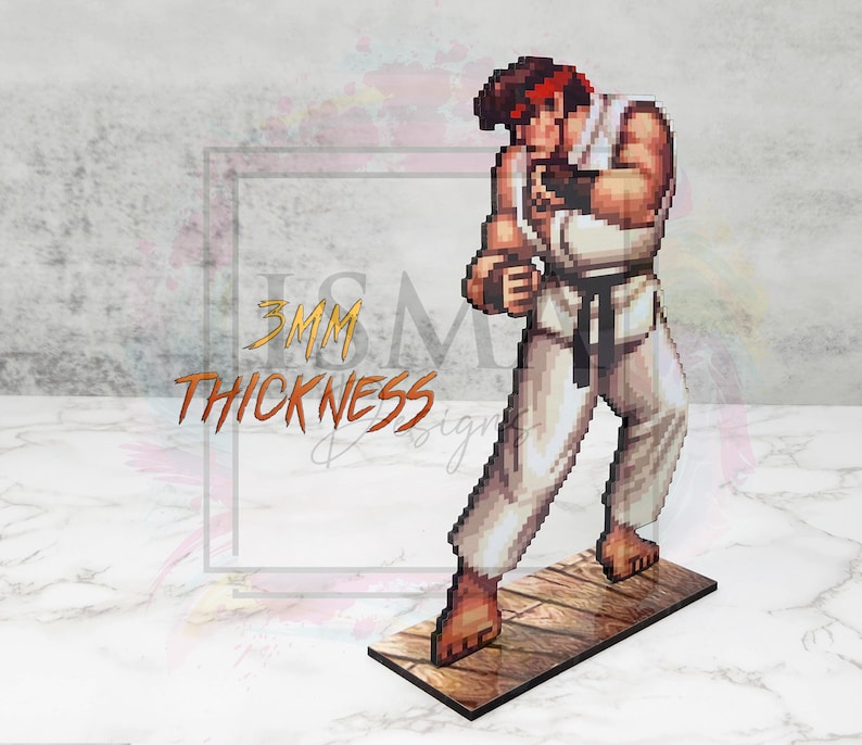 May include: A 3D printed figurine of a video game character, Ryu from Street Fighter, in a fighting pose. The figurine is made of wood and is 3mm thick. The figurine is painted in a pixelated style, similar to the original video game.