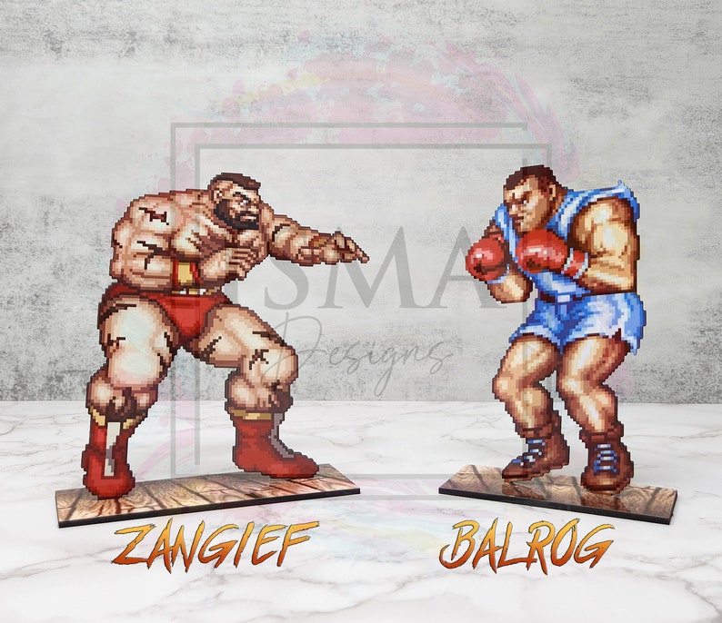 May include: Two pixel art figures of video game characters, ZANGIEF and BALROG, stand on wooden platforms. ZANGIEF is a muscular, red-clad wrestler with a beard, and BALROG is a boxer wearing blue shorts and red boxing gloves.