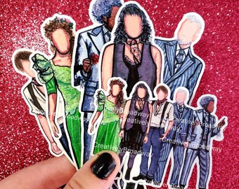 May include: Set of eight illustrated stickers featuring characters from a musical. The stickers are white with black outlines and feature characters in various poses and outfits. The stickers have the text "Creatively Broadway" printed on them.