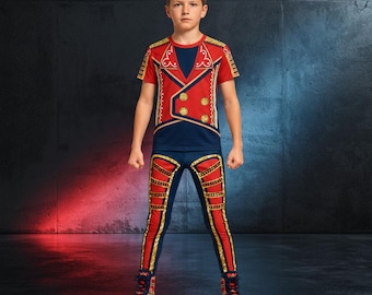 May include: A short-sleeved red and navy blue shirt featuring a gold-trimmed military-style jacket print with four gold buttons, paired with matching red and navy blue leggings that have gold-trimmed vertical stripes and gold accents on the legs.