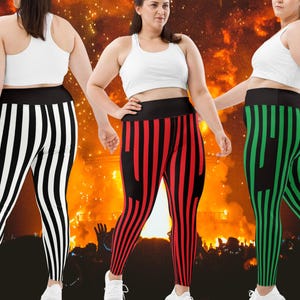 May include: Three pairs of high-waisted leggings in black and white, red and black, and green and black vertical stripes. Each pair has a wide black waistband and is paired with a white sports bra. The background is a blurred image of a crowd.