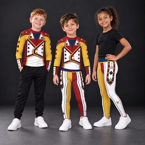 May include: Three children wearing circus-themed apparel. One wears a long-sleeve shirt with a red, yellow, and white soldier-style graphic and black joggers. Another wears a matching long-sleeve shirt and leggings. The third wears a black t-shirt.