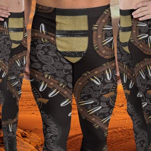 May include: Black leggings with a paisley pattern and brown leather accents. The leggings feature a design of bullets and a skull with horns.