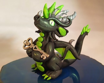 Handmade green and black dragon sculpture holding a key, figurine, model, polymer clay