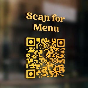 May include: A gold sticker with the text "Scan for Menu" and a black and white QR code.