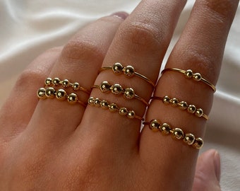 Simple golden anxiety rings with gold balls