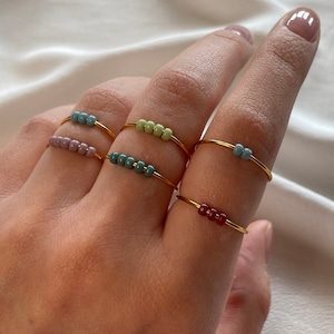 Simple golden anxiety rings with colorful glass beads image 1