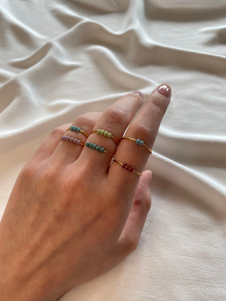 Simple golden anxiety rings with colorful glass beads image 1