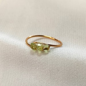 Simple ring with real peridot stones