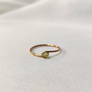 Simple gold ring with a small peridot stone