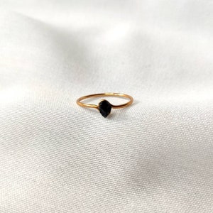 Simple gold ring with small black tourmaline stone