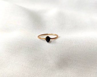Simple gold ring with small black tourmaline stone