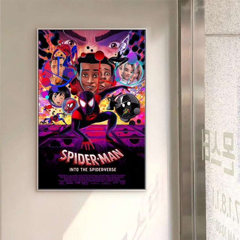 May include: A framed movie poster for "Spider-Man: Into the Spider-Verse." The poster features a vibrant collage of characters, including Spider-Man in a black and red suit, and the film's title in bold, stylized lettering.