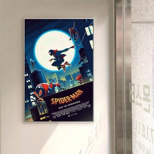 May include: A framed poster for "Spider-Man: Into the Spider-Verse" with Spider-Man characters in action against a cityscape. The poster features a large moon and the film's title text.