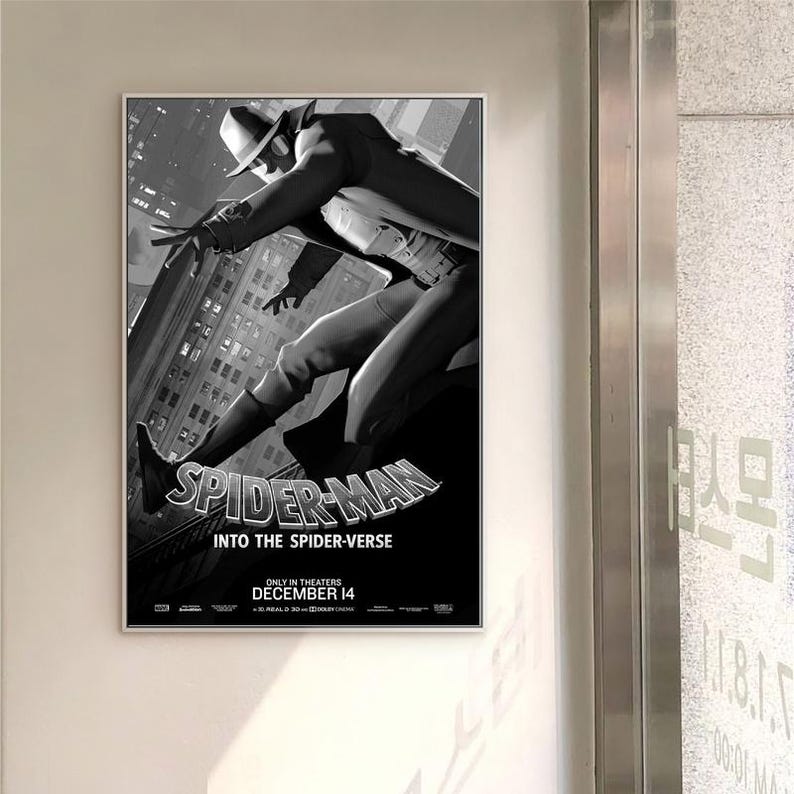 May include: A monochrome framed poster for the film "Spider-Man: Into the Spider-Verse." The image shows Spider-Man in a dynamic pose against a cityscape backdrop. The film's title is displayed, along with the release date, December 14.