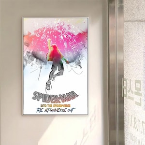 May include: Framed poster with a dynamic illustration of Spider-Man in a cityscape. The artwork shows a figure in mid-air with a vibrant pink and red sky, and the text "SPIDER-MAN INTO THE SPIDER-VERSE THE ALT-UNIVERSE CUT".