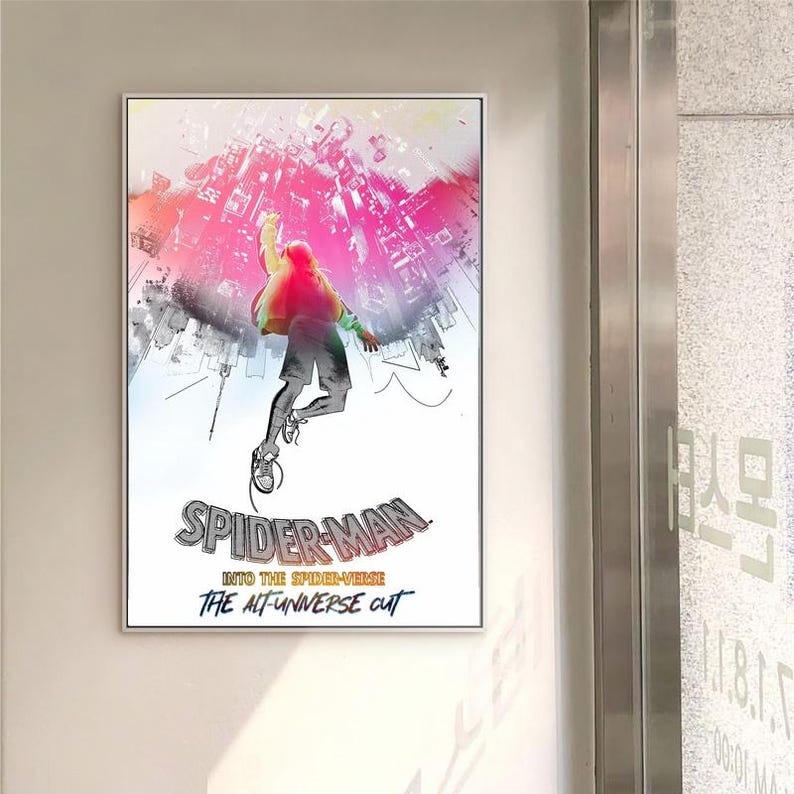 May include: Framed poster with a dynamic illustration of Spider-Man in a cityscape. The artwork shows a figure in mid-air with a vibrant pink and red sky, and the text "SPIDER-MAN INTO THE SPIDER-VERSE THE ALT-UNIVERSE CUT".