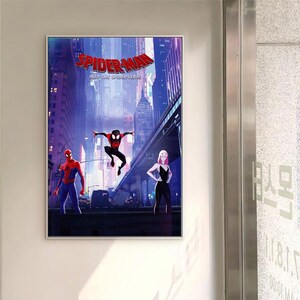May include: A framed poster featuring characters from the film "Spider-Man: Into the Spider-Verse." The artwork shows Spider-Man, Spider-Man Noir, and Spider-Gwen in a city scene with a bridge and skyscrapers. The title "SPIDER-MAN" is at the top.