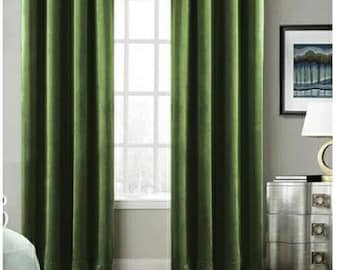 May include: A pair of dark green velvet curtains hanging in a window. The curtains are fully drawn and have a subtle sheen.