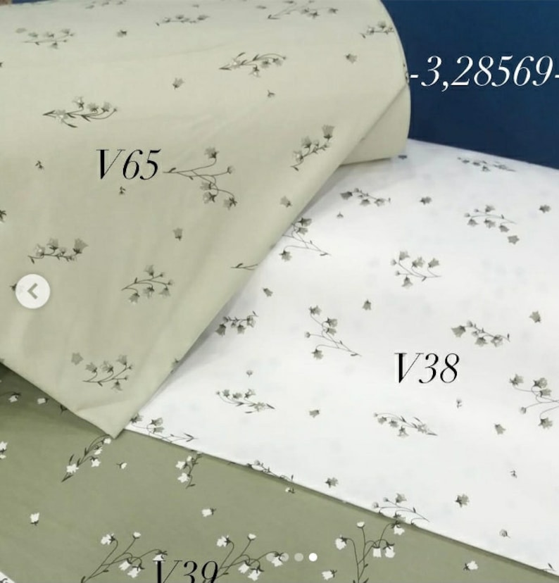 May include: Three fabric swatches with a floral pattern. The top swatch is a light green with a white floral pattern. The middle swatch is white with a gray floral pattern. The bottom swatch is a darker green with a white floral pattern. The swatches are labeled V65, V38, and V39.