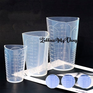 May include: Three clear plastic measuring cups with markings in ounces, milliliters, and cups. The largest cup is 500 ml, the middle cup is 250 ml, and the smallest cup is 150 ml.