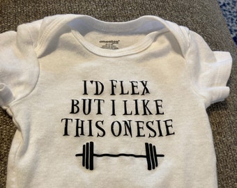 May include: White onesie with black text that reads "I'd flex but I like this onesie" and a black barbell graphic.