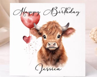 May include: A square greeting card featuring a watercolour illustration of a fluffy brown Highland cow with horns. The cow is next to two red heart-shaped balloons. The text Happy Birthday is printed at the top and the name Jessica is at the bottom.
